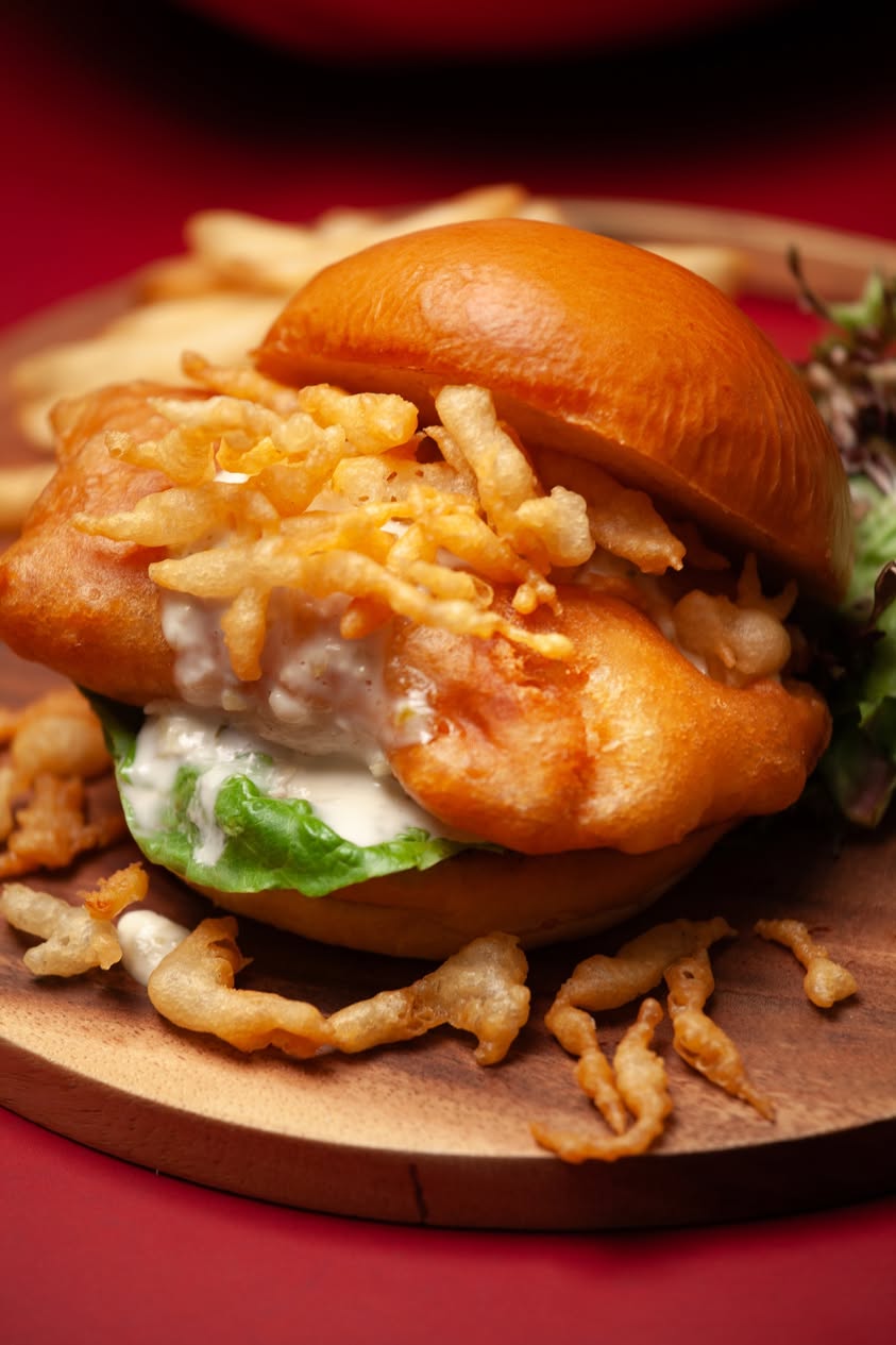 Swensen's Shiok Fish Burger on wooden serving board