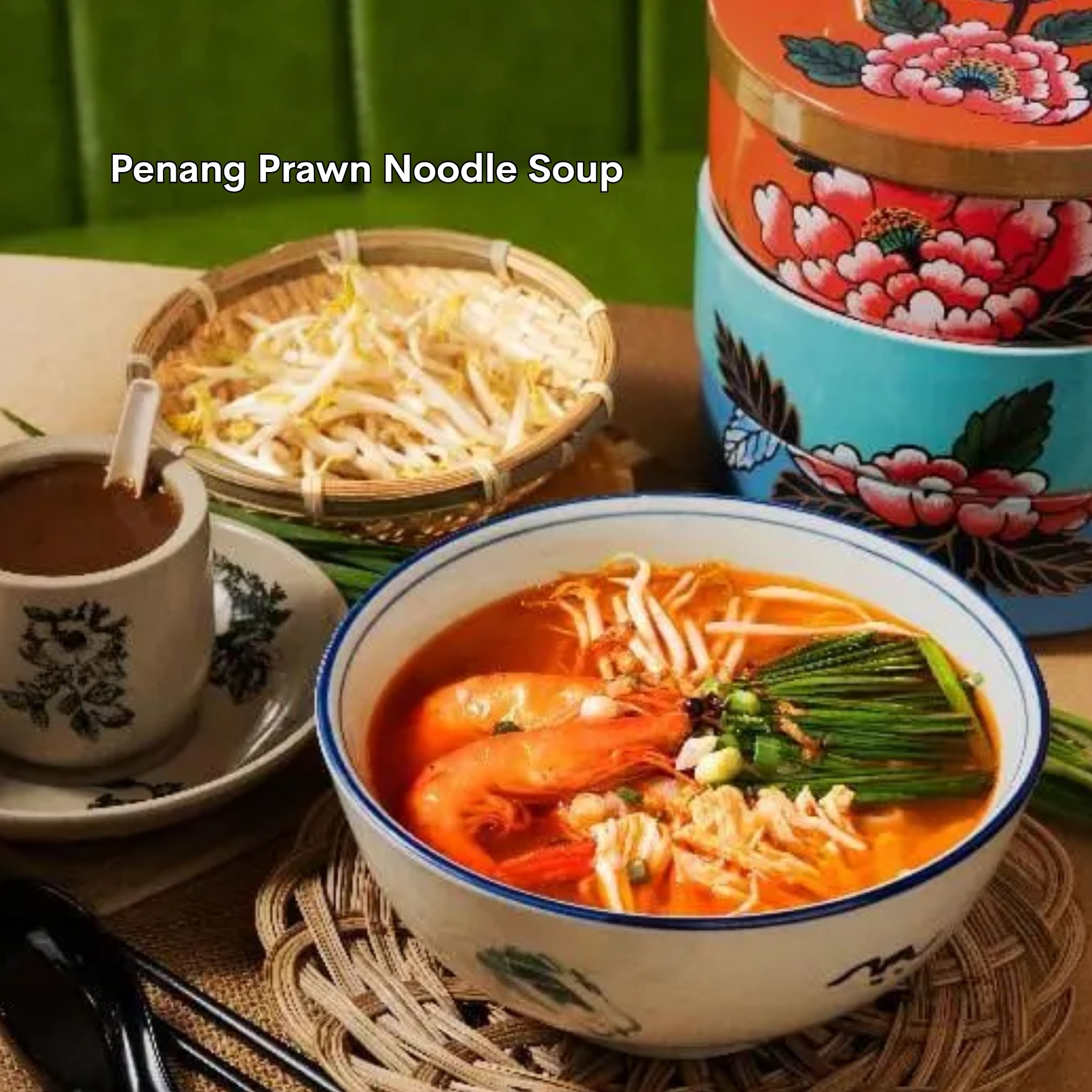 A steaming bowl of Penang Prawn Noodle Soup, a classic Malaysian dish.