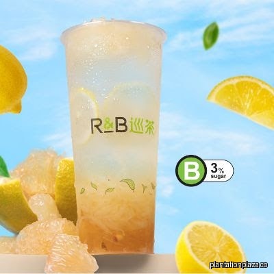 A refreshing drink with lemons and pomelo, featuring the R&B Tea logo.