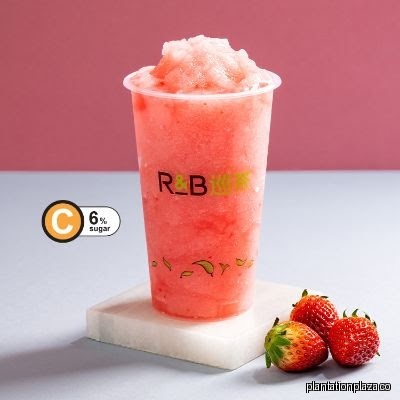 Strawberry drink with R&B Tea logo and fresh strawberries.