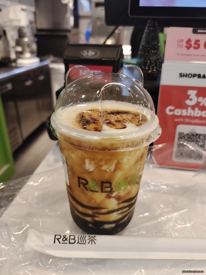 Close-up of a branded drink on a counter with promotional signs.