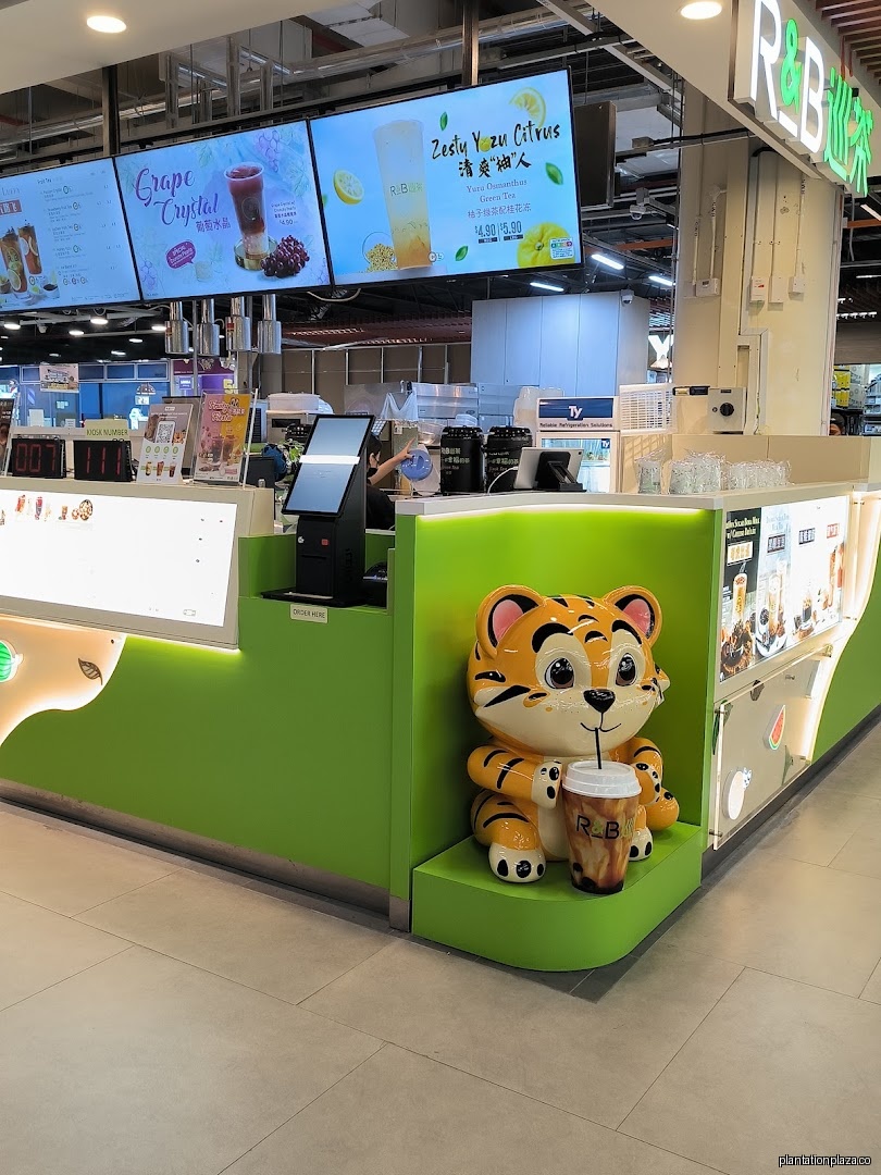 Bubble tea shop interior with counter, digital menus, and tiger mascot.