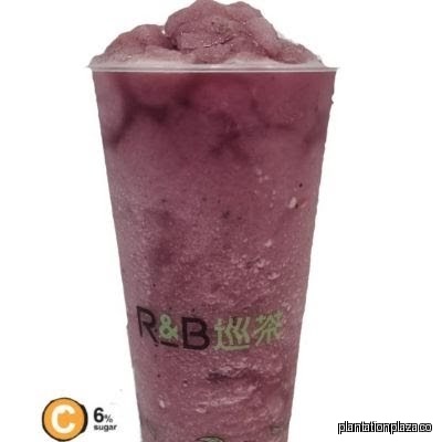 Close-up of a purple R&B Tea blended drink in a clear cup.